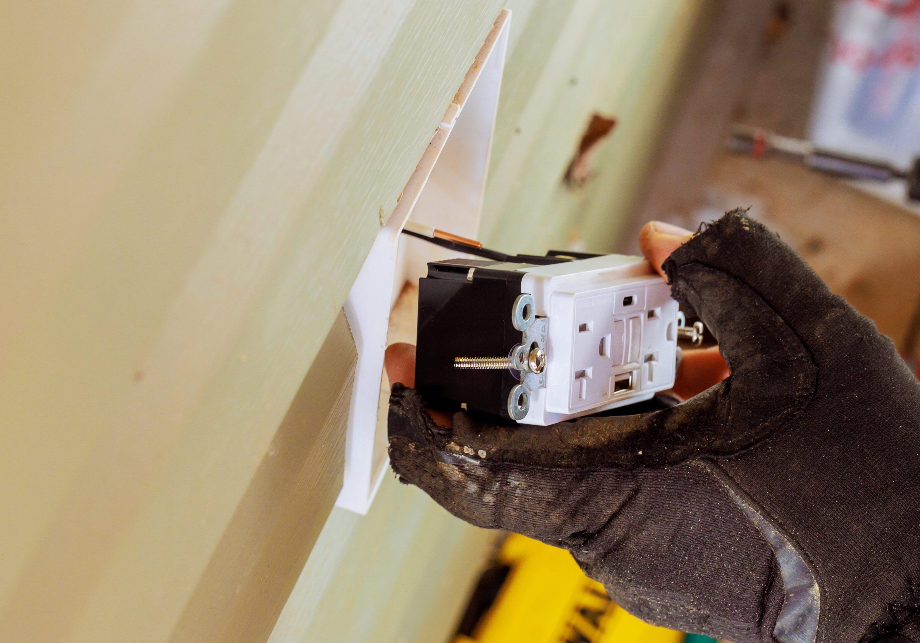 An electrical installation requires meticulous work to connect electrical wires to new outlets